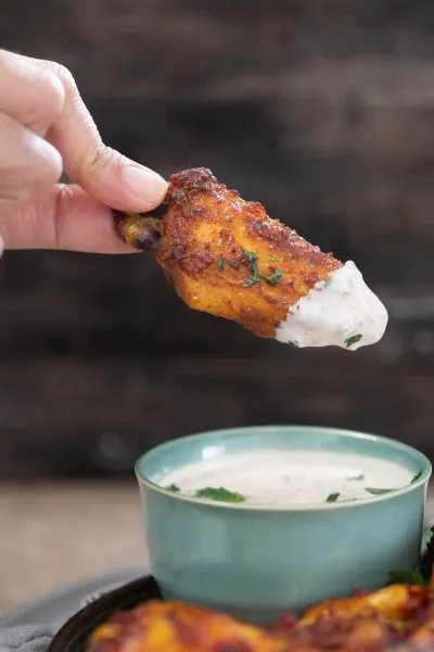 Tandoori chicken wing with cumin yogurt dip.