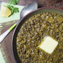 Bowl of black lentils with a pad of butter