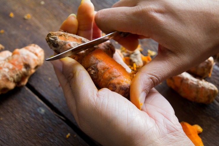 Peeling turmeric with a paring knife