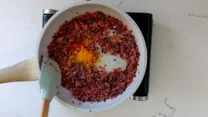 Stir in turmeric, chili powder and salt
