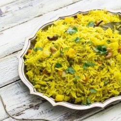 Pulao in a silver platter on a rustic background