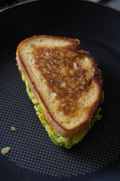 Masala cheese toast sandwich cooking on a pan
