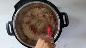 Add garlic, tomato paste, rice