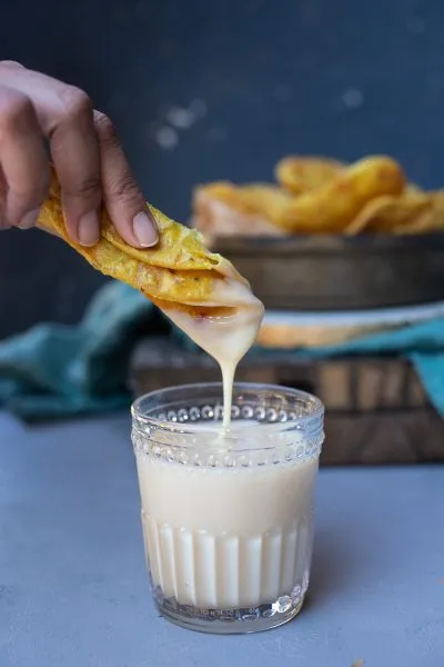 Dipping a masala puri in condensed milk