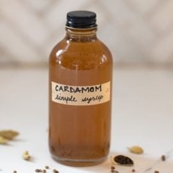 Cardamom simple syrup in a labelled bottle