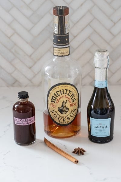 Ingredients of a chai bourbon fizz