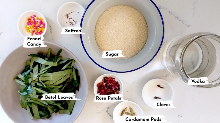 Ingredients for paan cordial: fennel candy, paan leaves, sugar, rose petals, cardamom pods, cloves, and vodka.