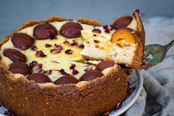 A pie spatula removing a slice of cake from the gulab jamun cheesecake