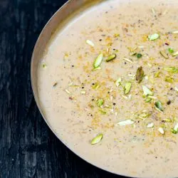 Bowl of kheer garnished with pistachios