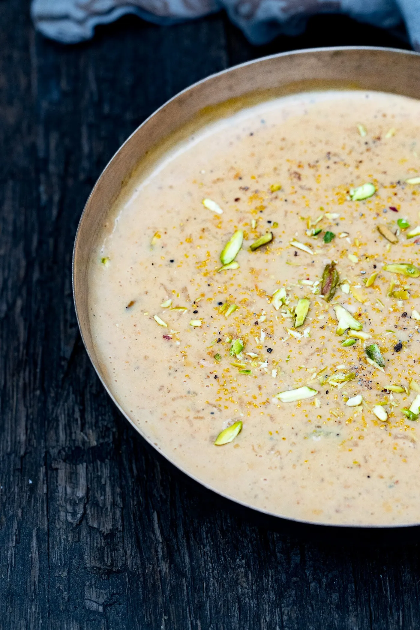 Bowl of kheer garnished with pistachios