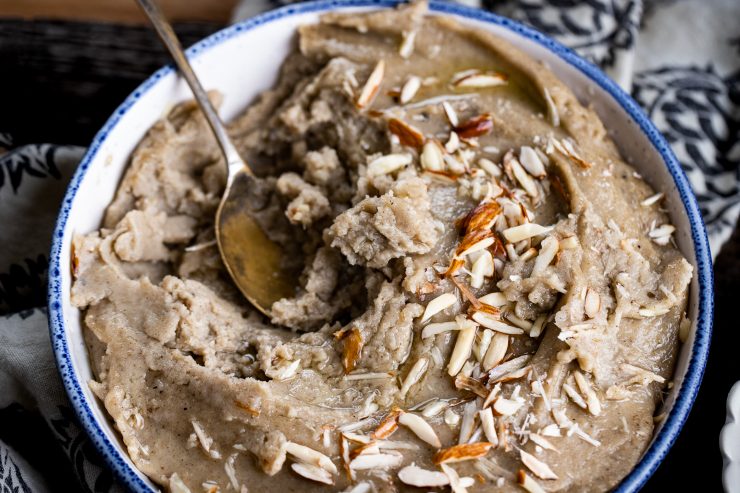 Bowl of bajra halwa with a spoon and some ghee