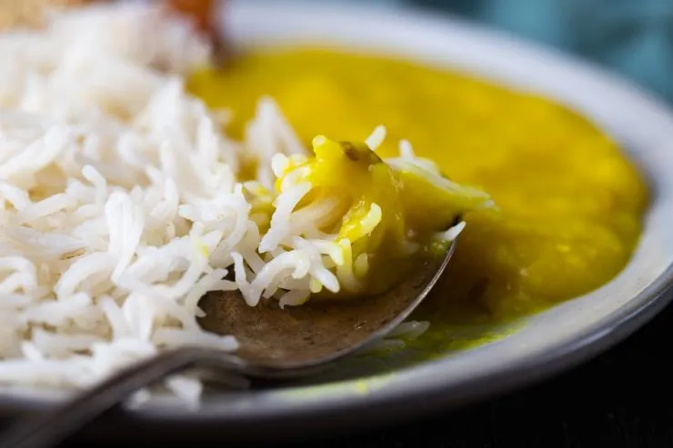Dal chawal on a plate with a spoon