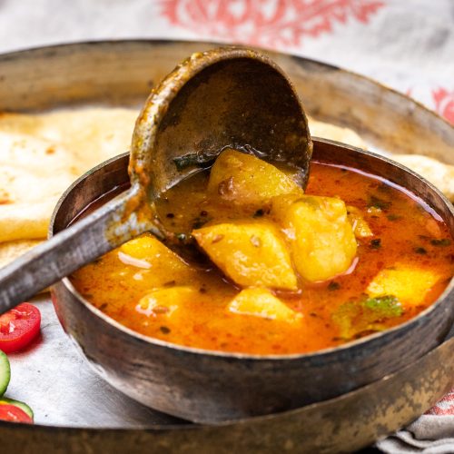 A tantalizing image of Batata nu Shaak, showcasing its vibrant colors and aromatic spices.