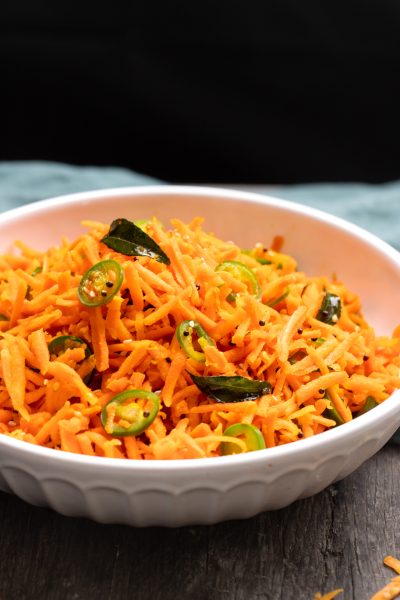 Bowl of carrot sambharo on a black background