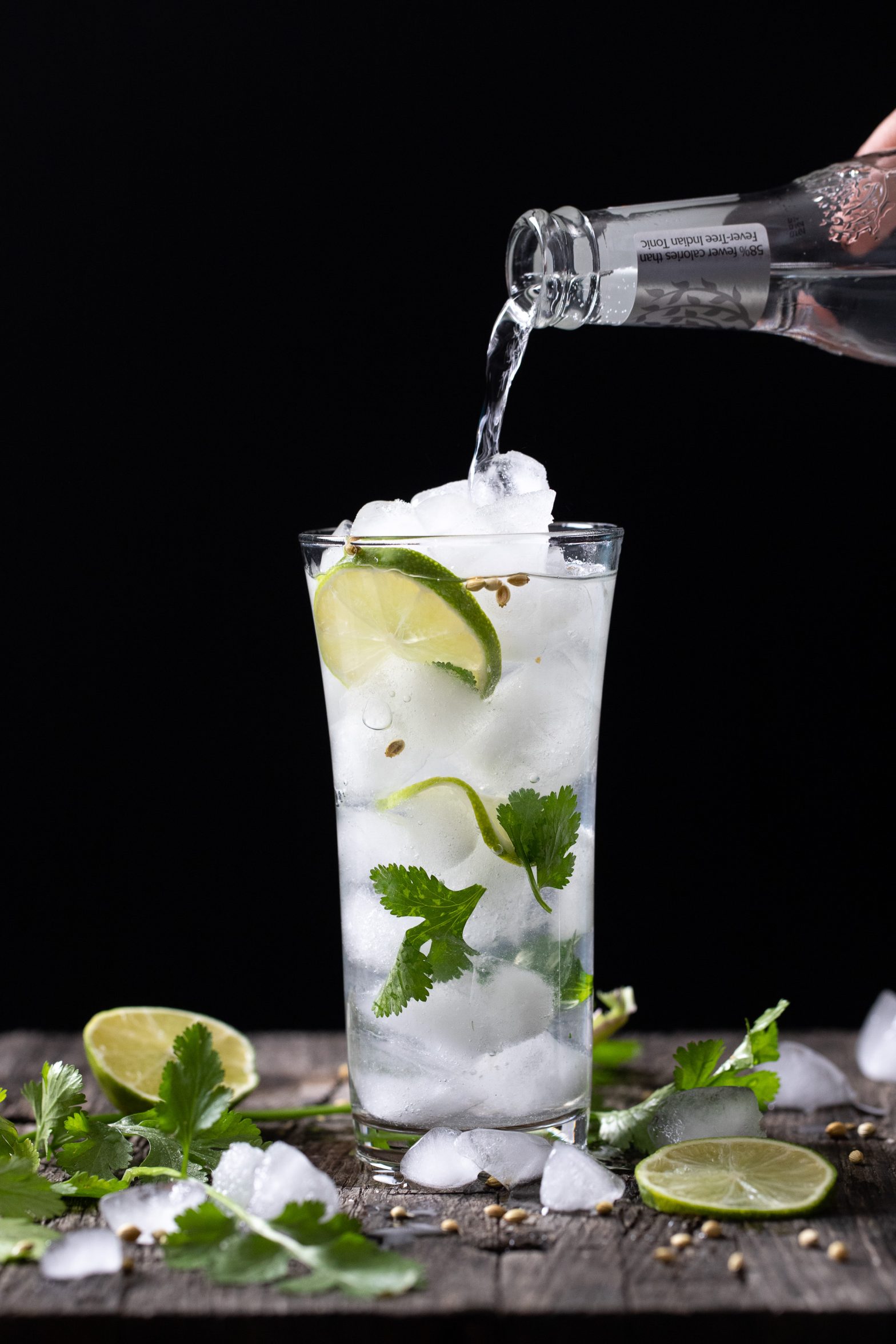 Pouring tonic into the cilantro gin and tonic