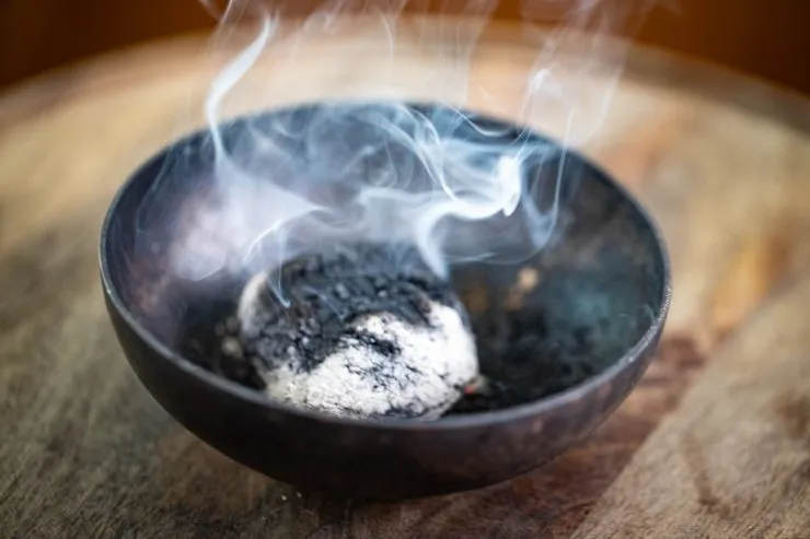 Charcoal smoking in a bowl