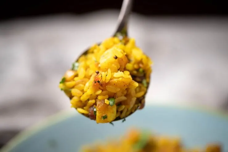 Close up of a spoonful of poha.