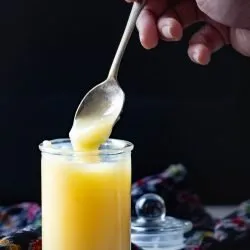 Spooning some ghee from a jar