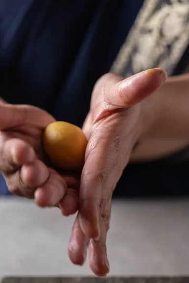 Rolling a ball of kesar peda