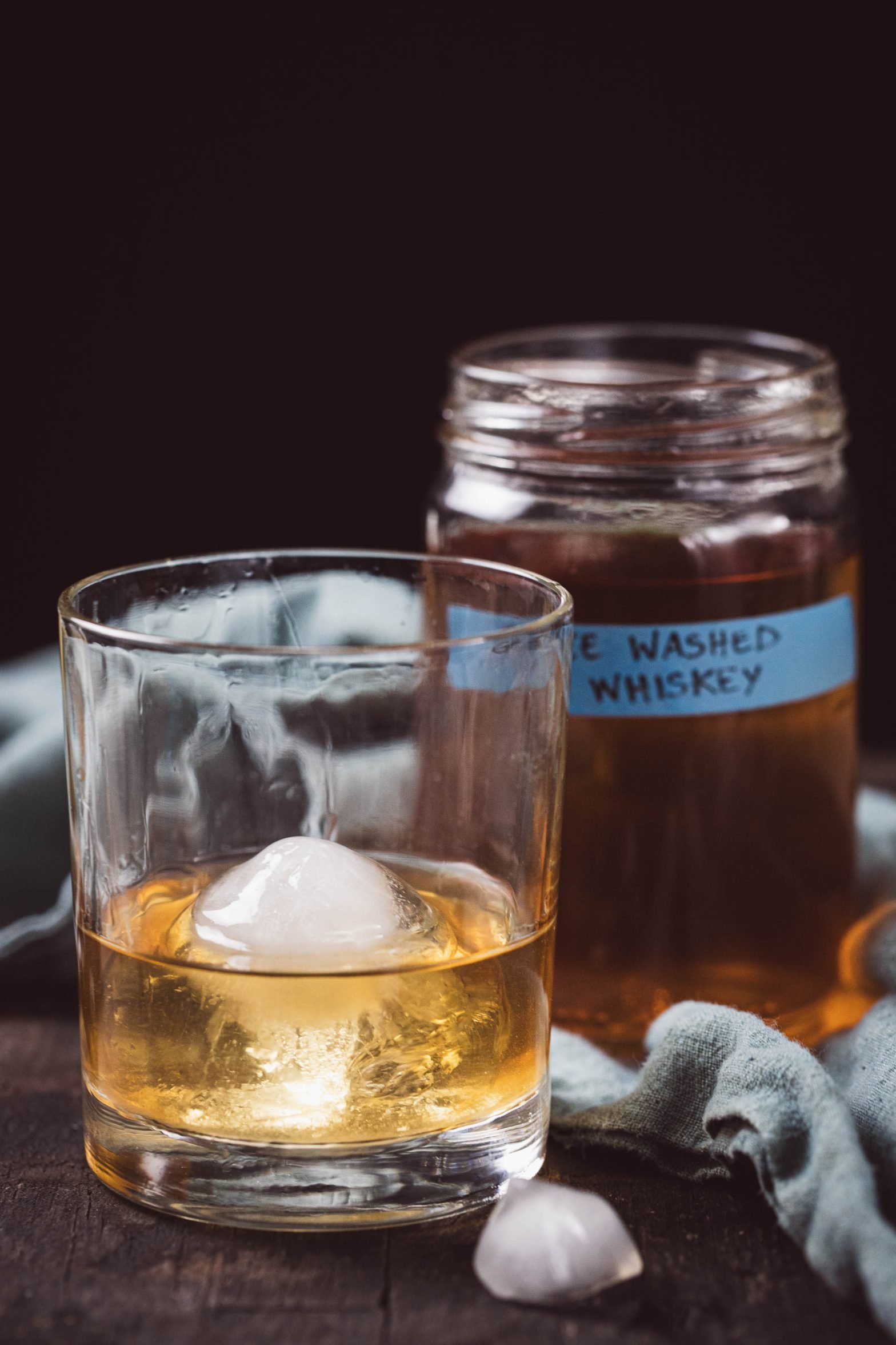 Ghee Washed Whiskey showing a glass and the jar.