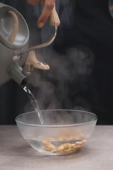 Pouring water over the cashews.