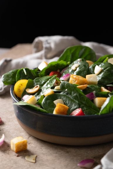Bowl of warm spinach and paneer salad.